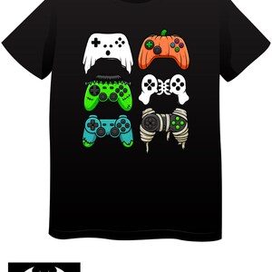May include: Black t-shirt featuring six stylized video game controllers in white, orange, green, and blue. The controllers have unique designs, including a pumpkin and mummy wrap. The Baby Batz logo is at the bottom.