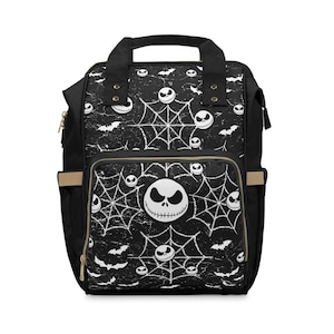May include: Black backpack featuring a white Jack Skellington face, spiderwebs, and bats. The bag has a top handle, a front pocket, and side pockets. The design is repeated across the bag's surface.