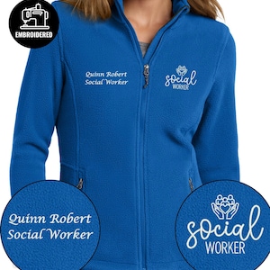 May include: Royal blue fleece jacket with a full zipper and two pockets. The jacket has the words "Quinn Robert Social Worker" embroidered on the left chest and "social WORKER" on the right chest. A logo that says "EMBROIDERED" is in the upper left corner.