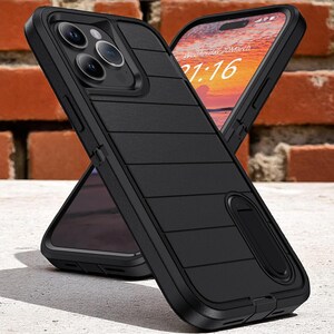 May include: Black phone case with a textured, horizontal-lined design. The case has a built-in kickstand and surrounds a phone displaying the date and time. The background is a brick wall.