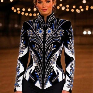 May include: A black zip-up jacket featuring intricate white and blue patterns, embellished with numerous clear and blue crystals arranged in floral and leaf-like motifs across the front and sleeves, with a high collar and fitted silhouette.