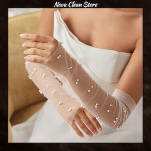 May include: Sheer white bridal gloves adorned with scattered faux pearls. The gloves are long, extending past the elbows, and are made of a delicate, see-through fabric. The text "Nova Clean Store" is at the top of the image.