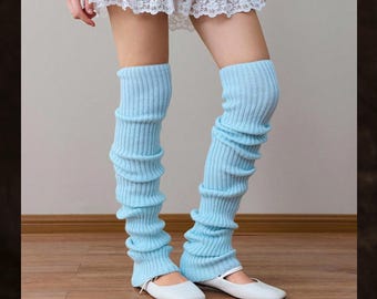May include: Light blue leg warmers with a ribbed texture. The leg warmers are worn with white flats. The text "Nova Clean Store" is visible at the top of the image. These leg warmers are a stylish accessory.