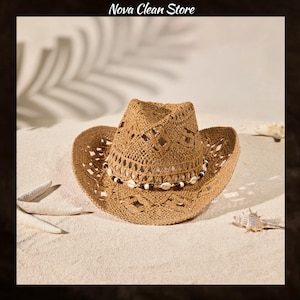 May include: A tan woven straw cowboy hat featuring an open-knit pattern and a decorative band made of small white seashells and dark brown beads. The text Nova Clean Store is visible at the top of the image above the hat.
