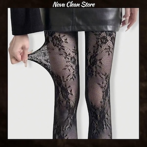 May include: Black fishnet tights featuring an intricate floral lace pattern. The hosiery is shown stretched to display the mesh texture and detailed embroidery. The text Nova Clean Store is visible at the top of the image above the black skirt.