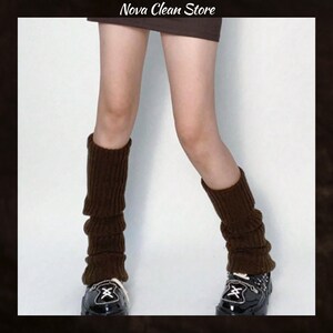 May include: Brown leg warmers made of a ribbed knit material. The leg warmers are worn over black shoes. The text "Nova Clean Store" is at the top of the image.