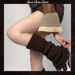 May include: Brown leg warmers made of a ribbed knit material. The leg warmers are being worn with a matching sleeve and shorts. The image also includes the text "Nova Clean Store".