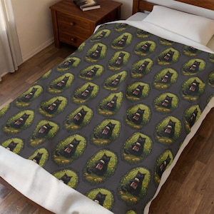 May include: A dark gray blanket featuring a repeating pattern of black cats sitting in green oval patches. Each cat is depicted holding a small, rectangular object with a red and white design. The blanket is spread over a bed with a white pillow.
