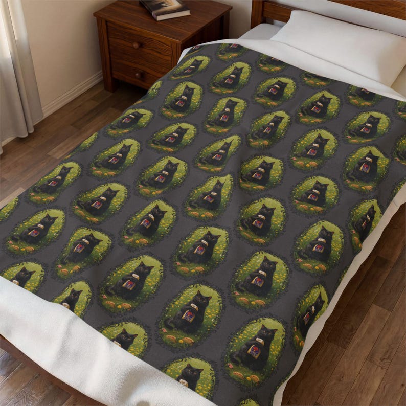 May include: A dark gray blanket featuring a repeating pattern of black cats sitting in green oval patches. Each cat is depicted holding a small, rectangular object with a red and white design. The blanket is spread over a bed with a white pillow.