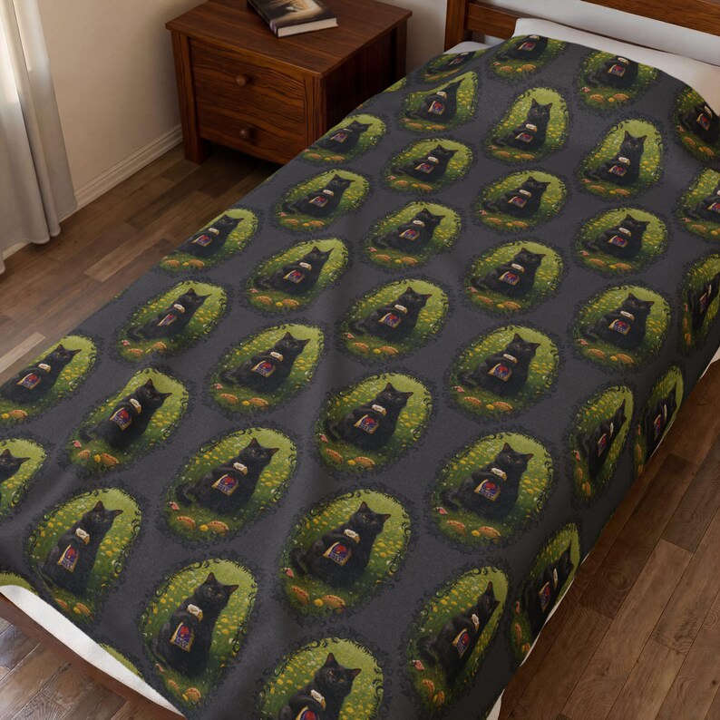 May include: A dark gray blanket featuring a repeating pattern of black cats sitting in green oval frames. Each cat is depicted holding a small, colorful book. The design is arranged in a grid across the entire surface of the fabric.