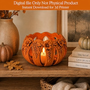 May include: An orange pumpkin-shaped candle holder with carved floral and leaf details, containing a lit candle. Text at the top reads: Digital file Only Not Physical Product. Instant Download for 3d Printer. The holder sits on a wooden surface.