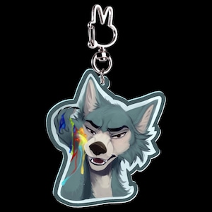May include: A keychain featuring a stylized wolf character with blue fur and a stern expression. The wolf has colorful paint streaks on its face. The keychain has a silver-colored clasp and a bunny-shaped charm.