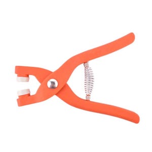 May include: Orange hand tool with white tips and a silver spring. The tool has two handles and a pivot point in the center. The tool is designed for making holes.