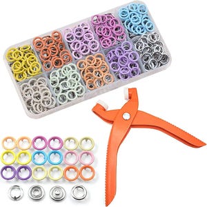 May include: A craft kit with a selection of colourful eyelets in a clear plastic organiser. The eyelets are in shades of yellow, orange, pink, purple, blue, and silver. An orange hand tool for setting the eyelets is also included.