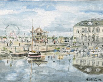 May include: Watercolor painting of a harbor scene with a Ferris wheel, carousel, and boats. A large building with arched windows and a green roof is on the right. The water reflects the buildings and sky.