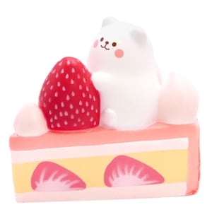 May include: A white cartoon bear figure sits atop a slice of strawberry cake. The cake has pink frosting, yellow layers, and strawberry slices. A large red strawberry is next to the bear.