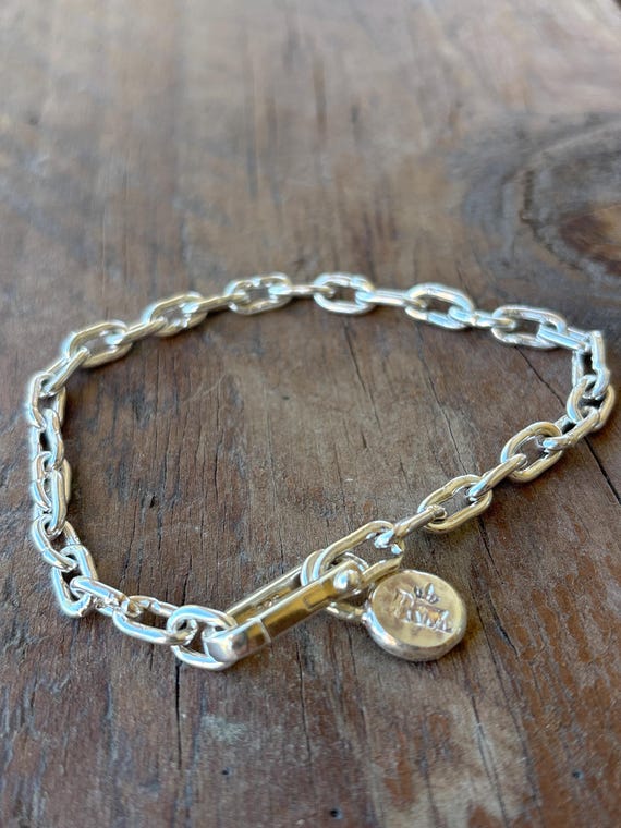 Solid hand-forged brass chain bracelet with 30 individual links — the kind of weighty, artisan-made piece that looks like it took real skill and time to create.