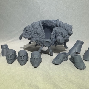May include: A collection of gray 3D-printed miniature figures, including multiple heads, boots, and a large, furry creature with a saddle-like structure. The figures are arranged on a neutral gray surface.