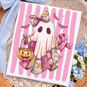 May include: A rectangular print featuring a white ghost character with a floral bow, holding an orange jack-o'-lantern bucket and a pink awareness ribbon. The ghost has a patchwork-style lower section with floral patterns against a pink striped background.