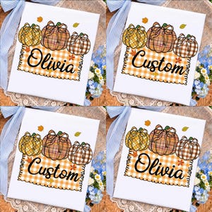 Può includere: Un quadrato di tessuto bianco con il disegno stampato di tre zucche a quadri con fiocchi, posizionato sopra un riquadro rettangolare a quadretti arancioni e bianchi. Il testo Olivia o Custom è stampato in nero sul riquadro.