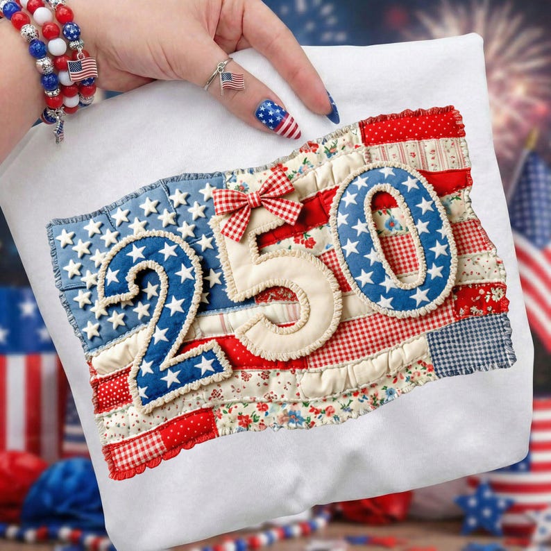 May include: White fabric with a patchwork design featuring the numbers "250" in blue and cream, adorned with white stars and a red and white gingham bow. The design incorporates red, white, and blue fabrics, resembling an American flag.
