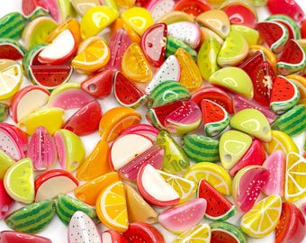 May include: A collection of colorful fruit-shaped beads, including watermelon, lemon, orange, and lime slices. The beads are in shades of red, green, yellow, and orange. These small, decorative beads are ideal for jewelry making and craft projects.