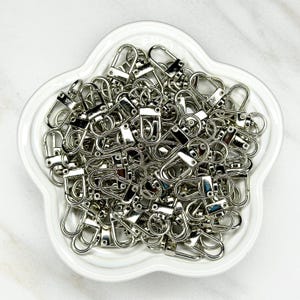Shiny silver and gold 12x33mm swivel lobster clasps for keychains, bag charms, jewelry making, and DIY craft supplies.