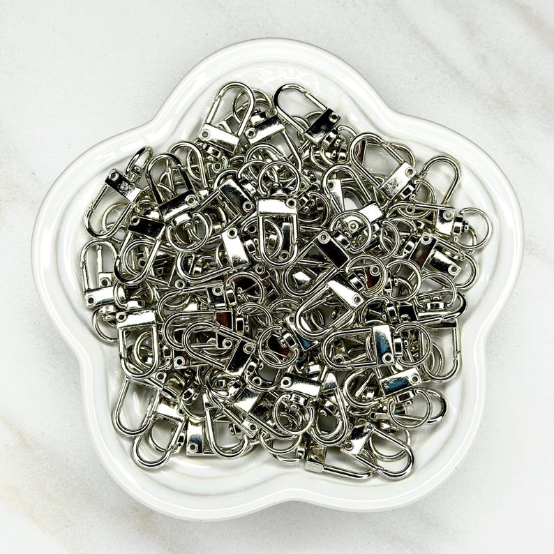 Shiny silver and gold 12x33mm swivel lobster clasps for keychains, bag charms, jewelry making, and DIY craft supplies.