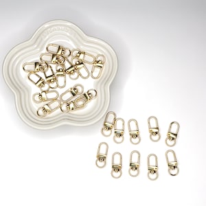 Shiny silver and gold 12x33mm swivel lobster clasps for keychains, bag charms, jewelry making, and DIY craft supplies.