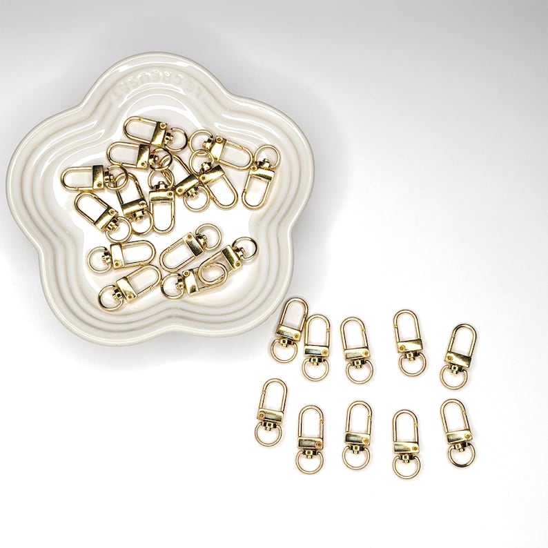 Shiny silver and gold 12x33mm swivel lobster clasps for keychains, bag charms, jewelry making, and DIY craft supplies.