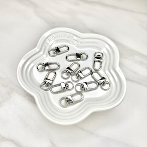 Shiny silver and gold 12x33mm swivel lobster clasps for keychains, bag charms, jewelry making, and DIY craft supplies.