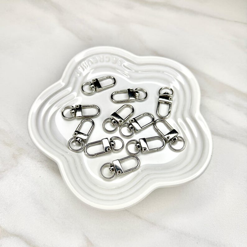 Shiny silver and gold 12x33mm swivel lobster clasps for keychains, bag charms, jewelry making, and DIY craft supplies.