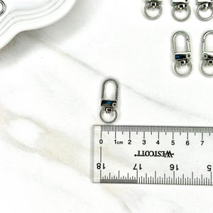 Shiny silver and gold 12x33mm swivel lobster clasps for keychains, bag charms, jewelry making, and DIY craft supplies.