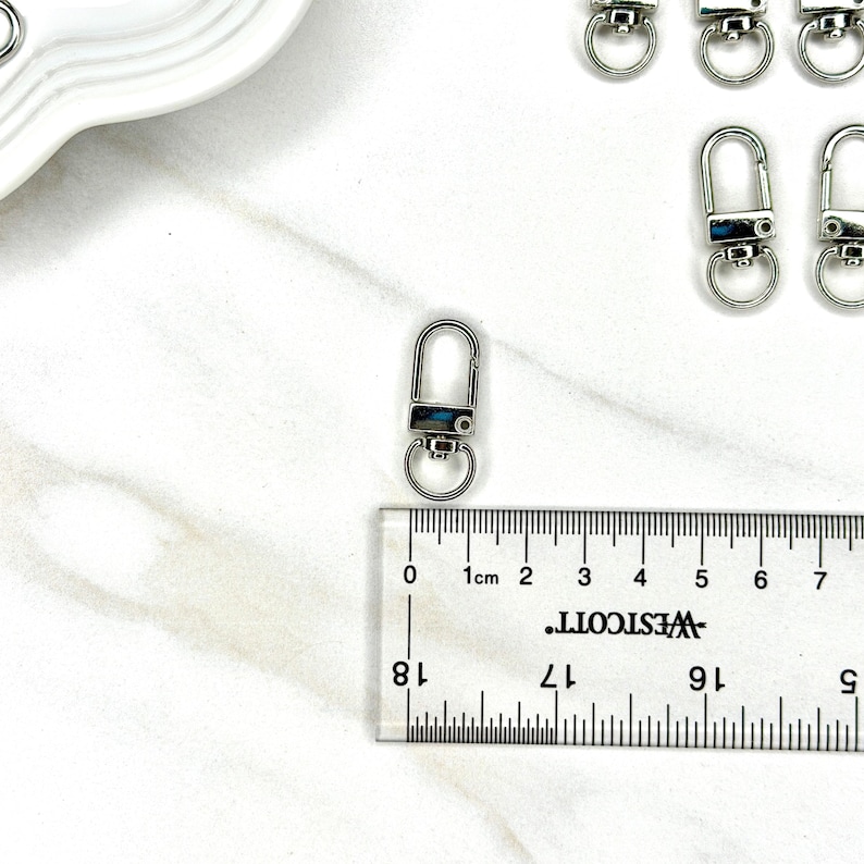 Shiny silver and gold 12x33mm swivel lobster clasps for keychains, bag charms, jewelry making, and DIY craft supplies.