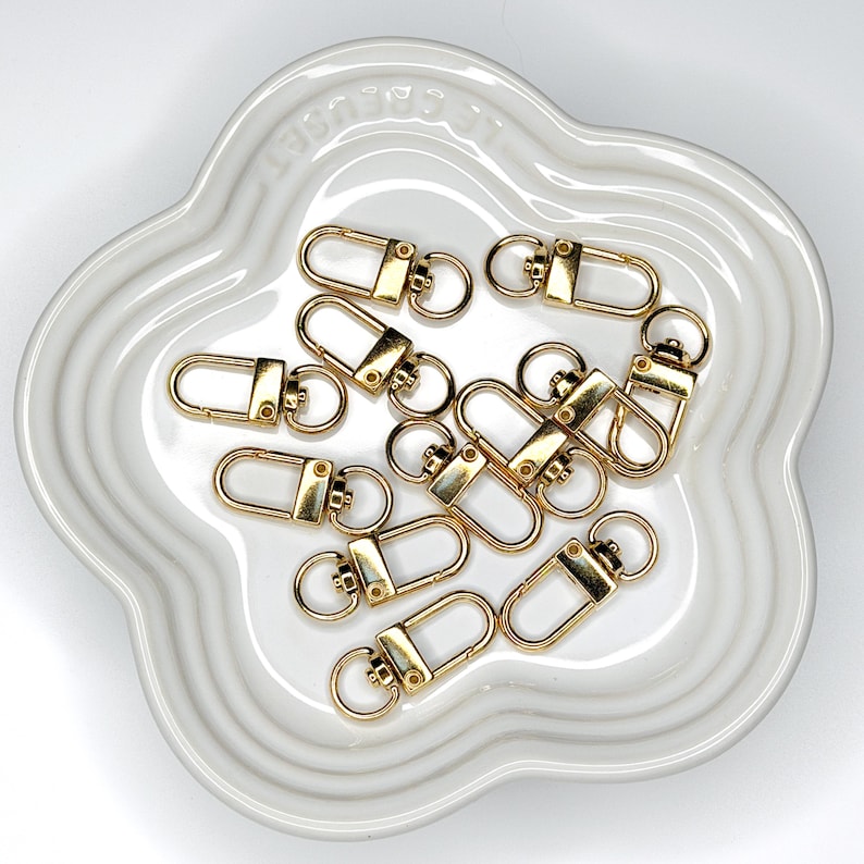 Shiny silver and gold 12x33mm swivel lobster clasps for keychains, bag charms, jewelry making, and DIY craft supplies.