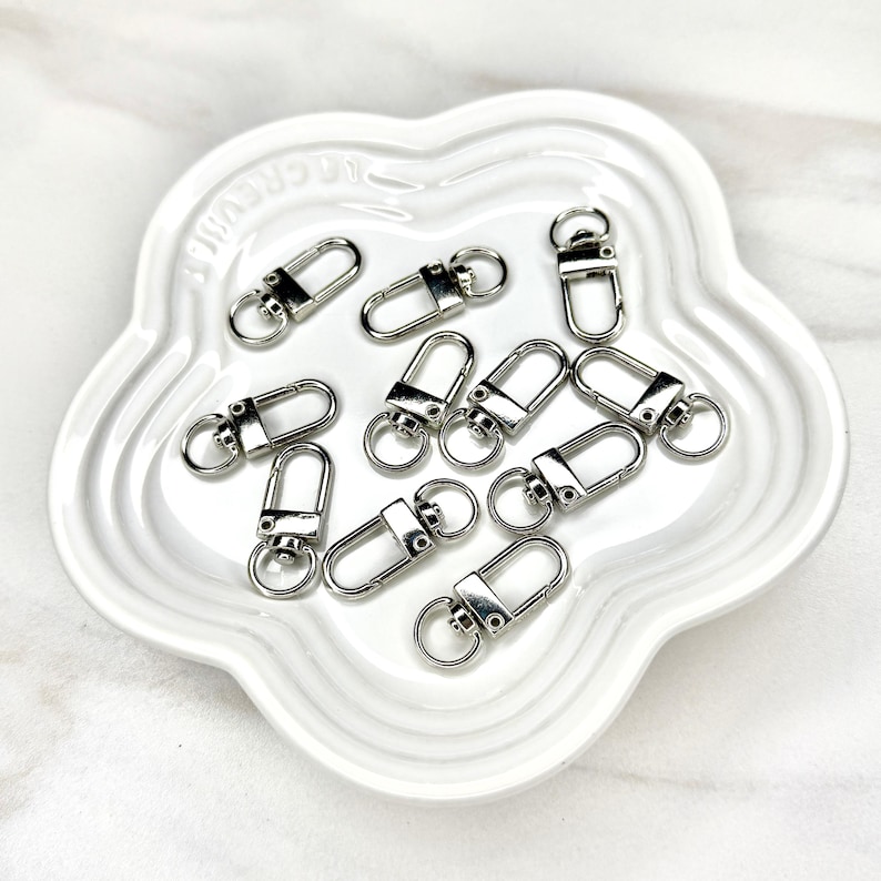 Shiny silver and gold 12x33mm swivel lobster clasps for keychains, bag charms, jewelry making, and DIY craft supplies.