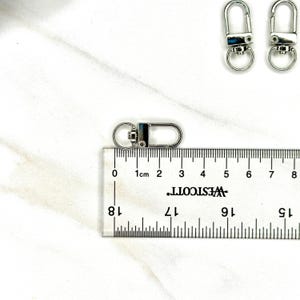Shiny silver and gold 12x33mm swivel lobster clasps for keychains, bag charms, jewelry making, and DIY craft supplies.