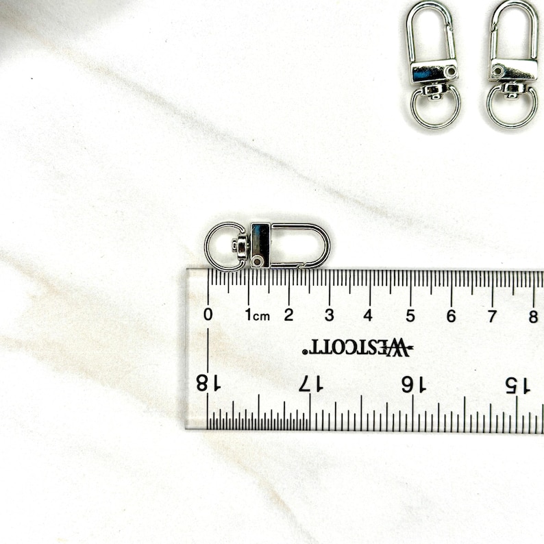 Shiny silver and gold 12x33mm swivel lobster clasps for keychains, bag charms, jewelry making, and DIY craft supplies.