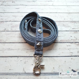May include: A blue denim dog leash with silver pyramid-shaped studs and a silver clip.
