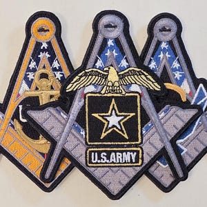 May include: Embroidered patches featuring Masonic symbols, including a compass and square design, with an anchor and the U.S. Army logo. The patches have a black border and are in shades of gold, gray, blue, and black.