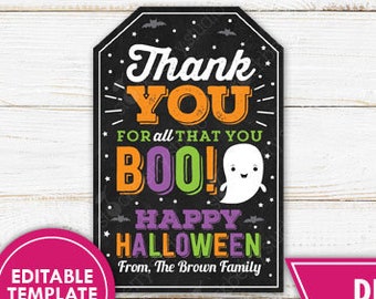 May include: A Halloween-themed printable tag with the words "Thank You" and "Boo!" in orange and purple. The tag also says "Happy Halloween" and features a ghost illustration. The tag is 9.5 cm high.