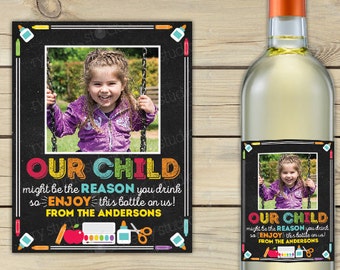 May include: A printable wine bottle label with a chalkboard background and colorful school supplies. The label features a photo of a child and the text "Our Child might be the reason you drink so ENJOY this bottle on us! From the Andersons."
