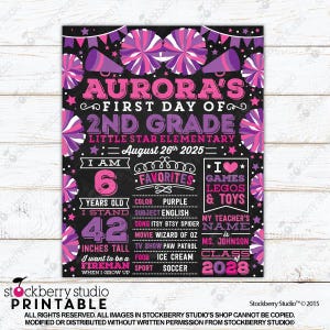 May include: A black chalkboard-style sign for a first day of 2nd grade, featuring pink and purple cheerleading pom-poms and megaphones. It displays text including Aurora's name, school, date, age of 6, height of 42 inches, and favorite interests.