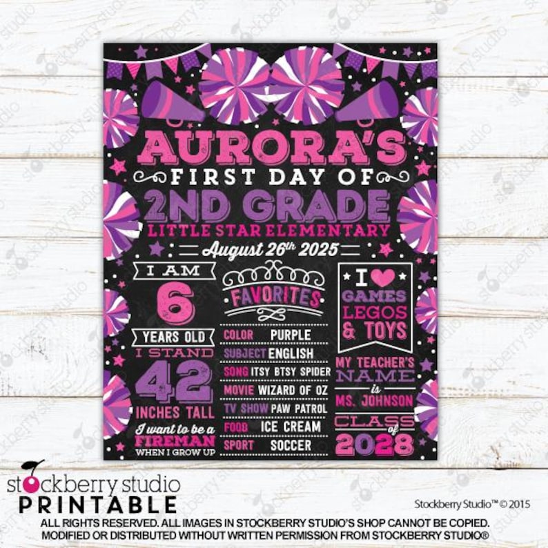 May include: A black chalkboard-style sign for a first day of 2nd grade, featuring pink and purple cheerleading pom-poms and megaphones. It displays text including Aurora's name, school, date, age of 6, height of 42 inches, and favorite interests.
