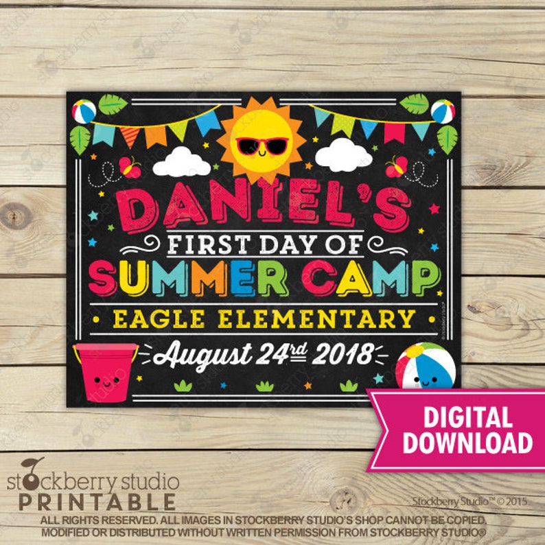 May include: A colourful chalkboard-style sign announcing "DANIEL'S FIRST DAY OF SUMMER CAMP". The sign features a smiling sun, beach balls, and the date August 24th, 2018. The words "EAGLE ELEMENTARY" are also included.