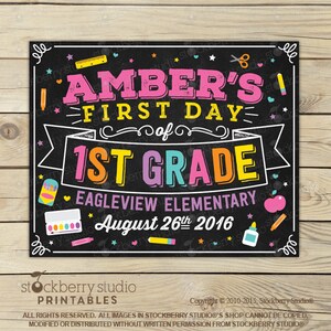 May include: A black chalkboard sign with the text "AMBER'S FIRST DAY of 1ST GRADE" in pink, yellow, and orange. The sign includes school-themed illustrations and the date "August 26th 2016".