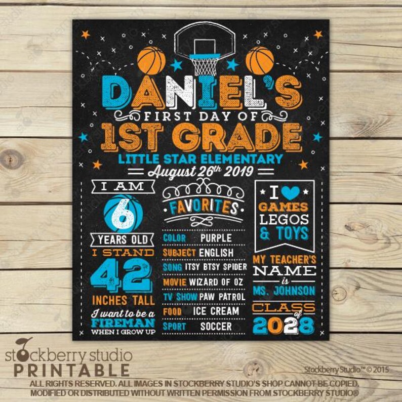 May include: A basketball-themed chalkboard sign for the first day of 1st grade. It features orange and blue text, including Daniel's name, school details, and personal favorites like age 6, 42 inches tall, and the goal to be a fireman.