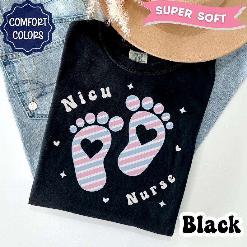 May include: A black t-shirt featuring the text "Nicu Nurse" in white lettering. The design includes two baby footprints with a pink, blue, and white striped pattern and a heart-shaped cutout in the center of each foot, surrounded by small white stars and hearts.
