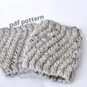 May include: A pair of gray knitted leg warmers with a textured pattern. The text "pdf pattern" is written above the leg warmers.
