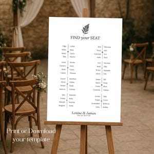 以下が含まれることがあります： 木製のイーゼルに立てられた白いウェディング席次表。チャートにはシダのグラフィックと上部に「FIND your SEAT」という言葉があります。名前は列にリストされています。チャートの下部には「Louise & James just get married」と書かれています。